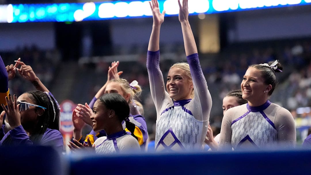 Mar 22, 2025; Birmingham AL, USA; LSU gymnast LSU gymnast Livvy Dunne celebrates with teammates during Session 2 of the SEC Gymnastics Championship at Legacy Arena in Birmingham, Alabama. LSU won the event to claim the SEC crown.