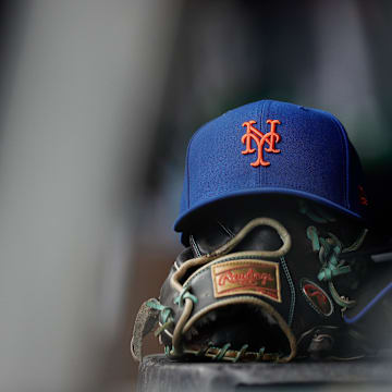 Aug 8, 2024; Denver, Colorado, USA; A New York Mets hat and glove in the dugout in the second inning against the Colorado Rockies at Coors Field. Mandatory Credit: Isaiah J. Downing-Imagn Images