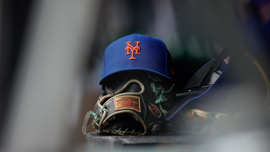 Aug 8, 2024; Denver, Colorado, USA; A New York Mets hat and glove in the dugout in the second inning against the Colorado Rockies at Coors Field. Mandatory Credit: Isaiah J. Downing-Imagn Images