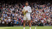 Jul 16, 2023; London, United Kingdom; Carlos Alcaraz (ESP) poses with the trophy after winning  the men   s singles final against Novak Djokovic (SRB) on day 14 at  the All England Lawn Tennis and Croquet Club. Mandatory Credit: Susan Mullane-USA TODAY Sports