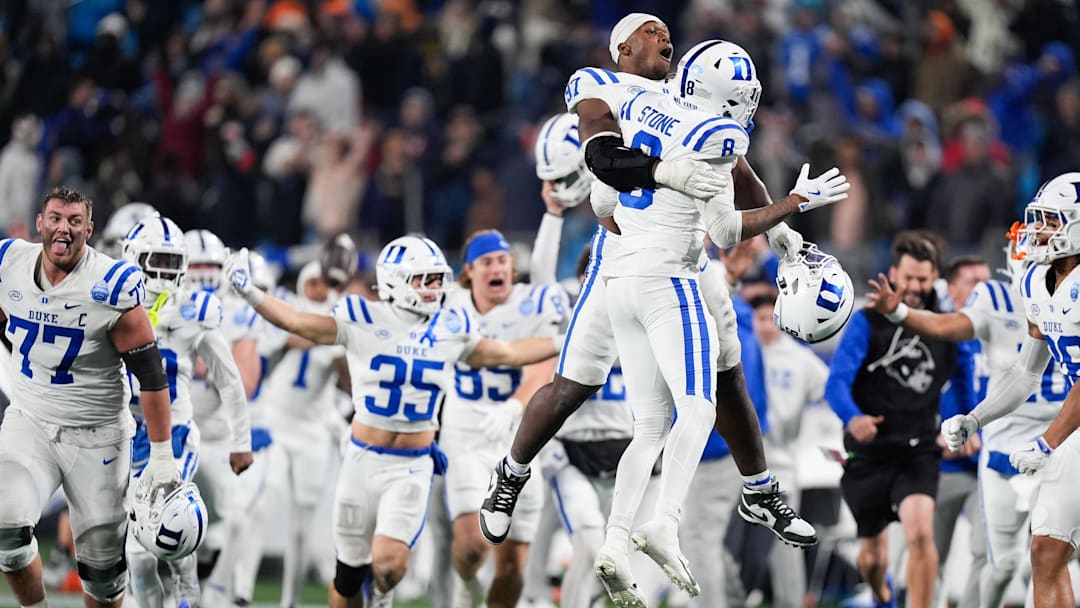 Dec 6, 2025; Charlotte, NC, USA; Duke Blue Devils defensive end Wesley Williams (97) celebrates with safety DaShawn Stone (8) after defeating the Virginia Cavaliers during the 2025 ACC Championship game at Bank of America Stadium. Mandatory Credit: Jim Dedmon-Imagn Images