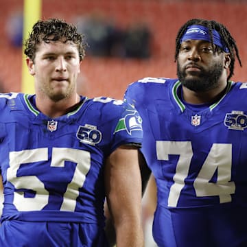 Nov 2, 2025; Landover, Maryland, USA; Seattle Seahawks linebacker Connor O'Toole (57) and Seahawks guard Josh Jones (74) walk off the field after defeating the Washington Commanders at Northwest Stadium. Mandatory Credit: Amber Searls-Imagn Images