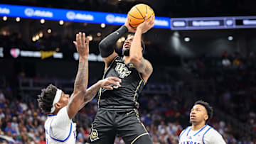 Mar 12, 2025; Kansas City, MO, USA; UCF Knights guard Darius Johnson (3) shoots the ball over Kansas Jayhawks forward Dillon Wilhite (22) during the second half at T-Mobile Center. Mandatory Credit: William Purnell-Imagn Images