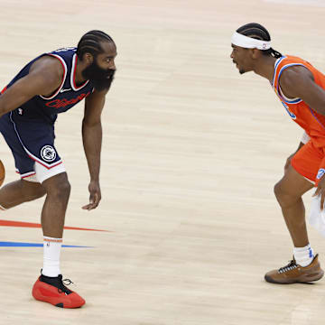 Nov 11, 2024; Oklahoma City, Oklahoma, USA; Los Angeles Clippers guard James Harden (1) dribbles the ball down the court as Oklahoma City Thunder guard Shai Gilgeous-Alexander (2) defends during the first quarter at Paycom Center. Mandatory Credit: Alonzo Adams-Imagn Images
