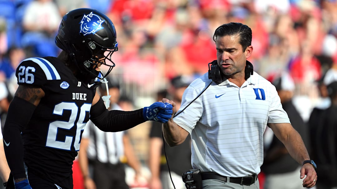 Sep 20, 2025; Durham, North Carolina, USA;  Duke Blue Devils head coach Manny Diaz interacts with safety Ma'khi Jones (26) during the first quarter against the NC State Wolfpack at Wallace Wade Stadium. Mandatory Credit: Zachary Taft-Imagn Images