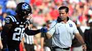 Sep 20, 2025; Durham, North Carolina, USA;  Duke Blue Devils head coach Manny Diaz interacts with safety Ma'khi Jones (26) during the first quarter against the NC State Wolfpack at Wallace Wade Stadium. Mandatory Credit: Zachary Taft-Imagn Images