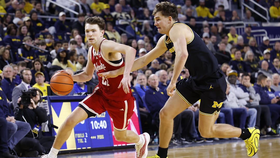 Jan 27, 2026; Ann Arbor, Michigan, USA;  Nebraska Cornhuskers forward Pryce Sandfort (21) dribbles on Michigan Wolverines forward Will Tschetter (42) in the second half at Crisler Center. Mandatory Credit: Rick Osentoski-Imagn Images