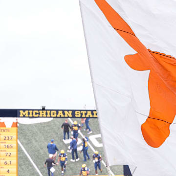 Texas wave their flag to celebrates a touchdown against Michigan during the first half at Michigan Stadium in Ann Arbor on Saturday, September 7, 2024.