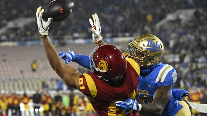 Nov 23, 2024; Pasadena, California, USA; USC Trojans wide receiver Kyle Ford (81) and UCLA Bruins defensive back Jaylin Davies (6) battle for an incomplete pass in the end zone during the second quarter at Rose Bowl. Mandatory Credit: Robert Hanashiro-Imagn Images Nov 23, 2024; Pasadena, California, USA; USC Trojans wide receiver Kyle Ford (81) and UCLA Bruins defensive back Jaylin Davies (6) battle for an incomplete pass in the end zone during the second quarter at Rose Bowl. Mandatory Credit: Robert Hanashiro-Imagn Images