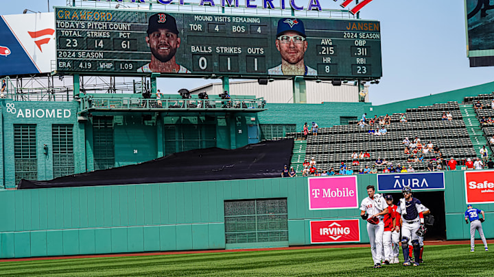 Aug 26, 2024; Boston, Massachusetts, USA; Boston Red Sox catcher Danny Jansen (28) makes his way to the dugout in a Boston Red Sox uniform while on the ball park score board when he was at bat during the postponed game back in June as a Toronto Blue Jays at Fenway Park. Mandatory Credit: David Butler II-Imagn Images