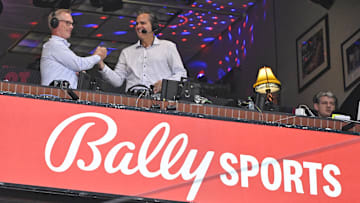 Jul 29, 2024; St. Louis, Missouri, USA;  Bally Sports broadcaster Chip Caray talks with broadcaster Joe Buck during the third inning of a game between the St. Louis Cardinals and the Texas Rangers at Busch Stadium. 
