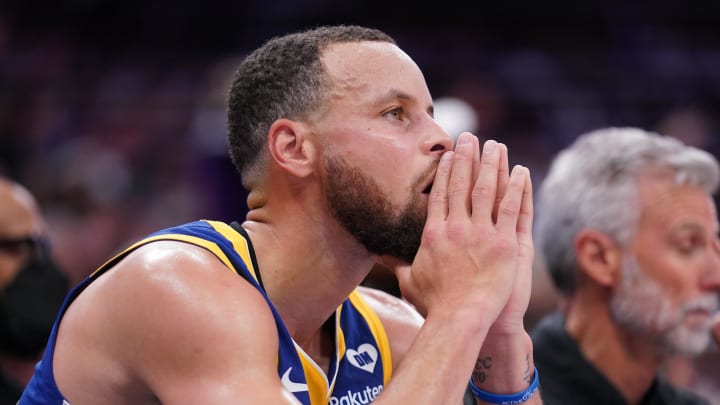 Apr 16, 2024; Sacramento, California, USA; Golden State Warriors guard Stephen Curry (30) sits on the bench during action against the Sacramento Kings in the fourth quarter during a play-in game of the 2024 NBA playoffs at the Golden 1 Center. 