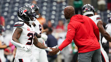 Sep 15, 2025; Houston, Texas, USA;  Houston Texans head coach DeMeco Ryans high fives Houston Texans running back Dare Ogunbowale (33) before the game against the Tampa Bay Buccaneers at NRG Stadium. Mandatory Credit: Thomas Shea-Imagn Images
