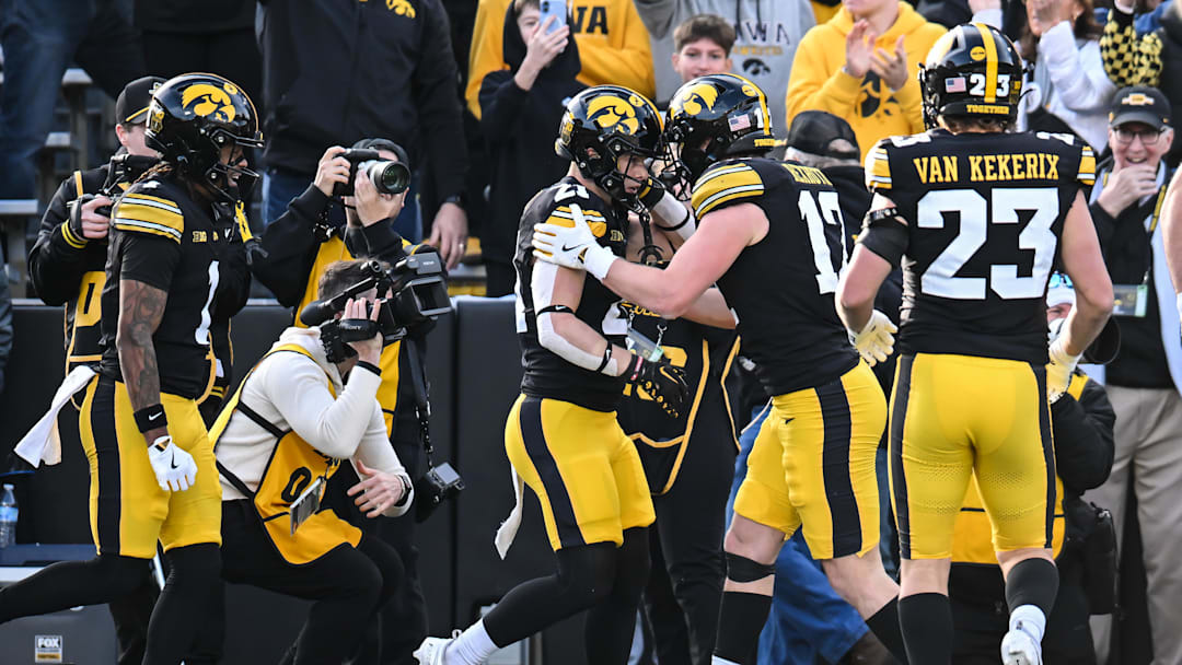 Nov 22, 2025; Iowa City, Iowa, USA; Iowa Hawkeyes wide receiver Kaden Wetjen (21) reacts with wide receiver Alex Eichmann (17) and teammates after scoring a touchdown on a punt return against the Michigan State Spartans during the second quarter at Kinnick Stadium. Mandatory Credit: Jeffrey Becker-Imagn Images Nov 22, 2025; Iowa City, Iowa, USA; Iowa Hawkeyes wide receiver Kaden Wetjen (21) reacts with wide receiver Alex Eichmann (17) and teammates after scoring a touchdown on a punt return against the Michigan State Spartans during the second quarter at Kinnick Stadium. Mandatory Credit: Jeffrey Becker-Imagn Images