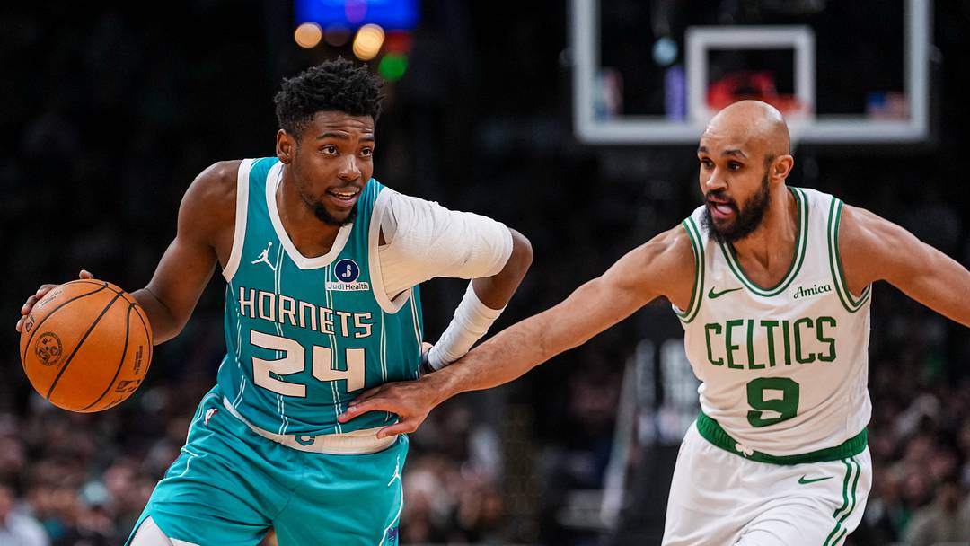 Charlotte Hornets forward Brandon Miller (24) drives the ball against Boston Celtics guard Derrick White 