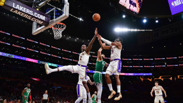 Dec 25, 2023; Los Angeles, California, USA; Los Angeles Lakers forward Jarred Vanderbilt (2) and forward Rui Hachimura (28) play for the rebound against Boston Celtics forward Jayson Tatum (0) during the second half at Crypto.com Arena. Mandatory Credit: Gary A. Vasquez-USA TODAY Sports