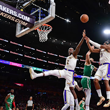 Dec 25, 2023; Los Angeles, California, USA; Los Angeles Lakers forward Jarred Vanderbilt (2) and forward Rui Hachimura (28) play for the rebound against Boston Celtics forward Jayson Tatum (0) during the second half at Crypto.com Arena. Mandatory Credit: Gary A. Vasquez-Imagn Images