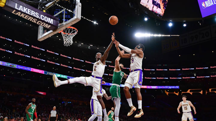 Dec 25, 2023; Los Angeles, California, USA; Los Angeles Lakers forward Jarred Vanderbilt (2) and forward Rui Hachimura (28) play for the rebound against Boston Celtics forward Jayson Tatum (0) during the second half at Crypto.com Arena. Mandatory Credit: Gary A. Vasquez-USA TODAY Sports