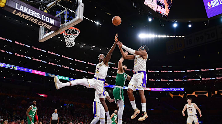 Dec 25, 2023; Los Angeles, California, USA; Los Angeles Lakers forward Jarred Vanderbilt (2) and forward Rui Hachimura (28) play for the rebound against Boston Celtics forward Jayson Tatum (0) during the second half at Crypto.com Arena. Mandatory Credit: Gary A. Vasquez-Imagn Images