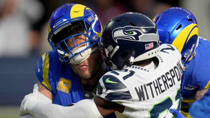 Nov 19, 2023; Inglewood, California, USA;  Seattle Seahawks cornerback Devon Witherspoon (21) sacks Los Angeles Rams quarterback Matthew Stafford (9) in the first quarter at SoFi Stadium. Mandatory Credit: Kirby Lee-USA TODAY Sports