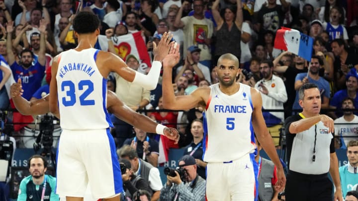 Aug 8, 2024; Paris, France; France power forward Victor Wembanyama (32) and small forward Nicolas Batum (5) celebrate during the second half against Germany in a men's basketball semifinal game during the Paris 2024 Olympic Summer Games at Accor Arena. 