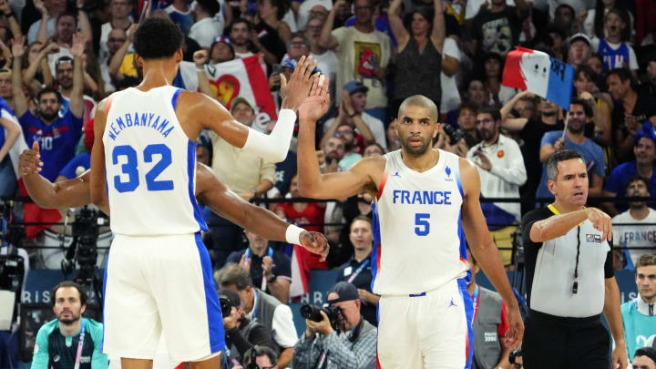 Aug 8, 2024; Paris, France; France power forward Victor Wembanyama (32) and small forward Nicolas Batum (5) celebrate during the second half against Germany in a men's basketball semifinal game during the Paris 2024 Olympic Summer Games at Accor Arena. 