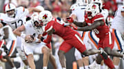 Oct 4, 2025; Louisville, Kentucky, USA; Louisville Cardinals linebacker Antonio Watts (9) sacks Virginia Cavaliers quarterback Chandler Morris (4) during the second half at L&N Federal Credit Union Stadium. Virginia defeated Louisville 30-27. Mandatory Credit: Jamie Rhodes-Imagn Images
