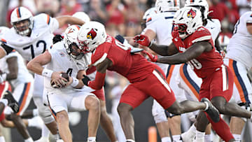 Oct 4, 2025; Louisville, Kentucky, USA; Louisville Cardinals linebacker Antonio Watts (9) sacks Virginia Cavaliers quarterback Chandler Morris (4) during the second half at L&N Federal Credit Union Stadium. Virginia defeated Louisville 30-27. Mandatory Credit: Jamie Rhodes-Imagn Images