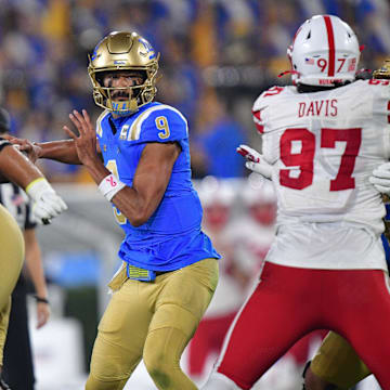 Nov 8, 2025; Pasadena, California, USA; UCLA Bruins quarterback Nico Iamaleava (9) throws against the Nebraska Cornhuskers during the first half at the Rose Bowl. Mandatory Credit: Gary A. Vasquez-Imagn Images