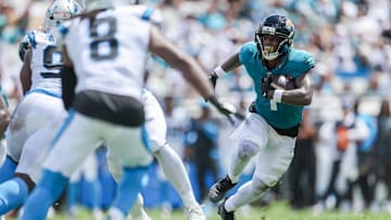 Sep 7, 2025; Jacksonville, Florida, USA; Jacksonville Jaguars running back Travis Etienne Jr. (1) carries the ball against the Carolina Panthers during the first half at EverBank Stadium. Mandatory Credit: Nathan Ray Seebeck-Imagn Images