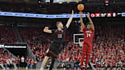 Mar 8, 2025; Louisville, Kentucky, USA;  Louisville Cardinals guard Chucky Hepburn (24) shoots against Stanford Cardinal forward Aidan Cammann (52) during the second half at KFC Yum! Center. Louisville defeated Stanford 68-48. Mandatory Credit: Jamie Rhodes-Imagn Images