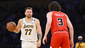 Mar 22, 2025; Los Angeles, California, USA; Los Angeles Lakers guard Luka Doncic (77) dribbles the ball against Chicago Bulls guard Josh Giddey (3) during the first half at Crypto.com Arena. Mandatory Credit: Jonathan Hui-Imagn Images