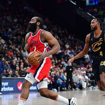 Mar 18, 2025; Inglewood, California, USA; Los Angeles Clippers guard James Harden (1) moves to the basket ahead of Cleveland Cavaliers forward Evan Mobley (4) during the second half at Intuit Dome. Mandatory Credit: Gary A. Vasquez-Imagn Images