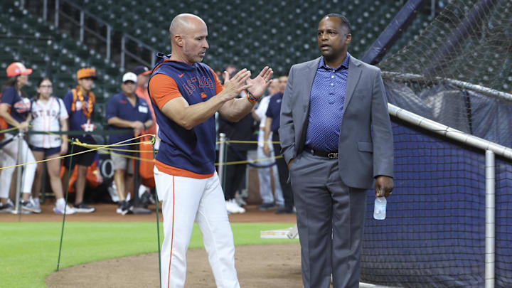 Jun 28, 2025; Houston, Texas, USA; Houston Astros manager Joe Espada (left) and general manager Dana Brown (right) talk on the field before the game against the Chicago Cubs at Daikin Park. Mandatory Credit: Troy Taormina-Imagn Images