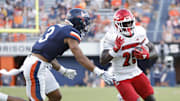 Oct 12, 2024; Charlottesville, Virginia, USA; Louisville Cardinals running back Isaac Brown (25) carries the ball past Virginia Cavaliers safety Corey Thomas Jr. (3) to score a touchdown during the second half at Scott Stadium. Mandatory Credit: Amber Searls-Imagn Images