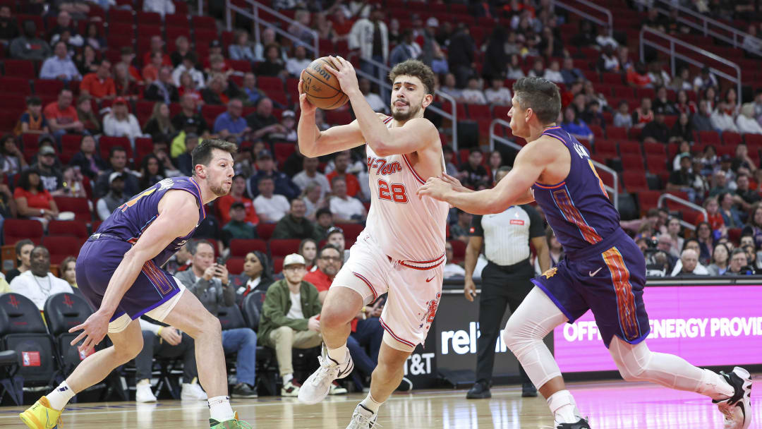 Feb 23, 2024; Houston, Texas, USA; Houston Rockets center Alperen Sengun (28) drives with the ball as Phoenix Suns guard Grayson Allen (8) defends during the first quarter at Toyota Center. Mandatory Credit: Troy Taormina-USA TODAY Sports