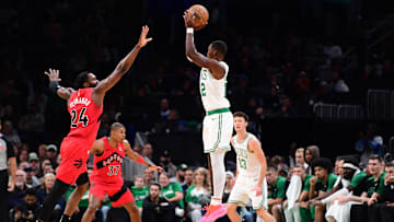 Oct 13, 2024; Boston, Massachusetts, USA;  Boston Celtics guard Lonnie Walker IV (12) shoots the ball past Toronto Raptors forward Bruno Fernando (24) during the second half at TD Garden. Mandatory Credit: Bob DeChiara-Imagn Images