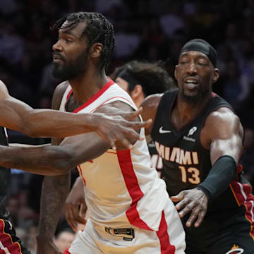 Mar 21, 2025; Miami, Florida, USA;  Houston Rockets forward Tari Eason (17) passes around Miami Heat forward Andrew Wiggins (22) as center Bam Adebayo (13) closes in during the first half at Kaseya Center. Mandatory Credit: Jim Rassol-Imagn Images