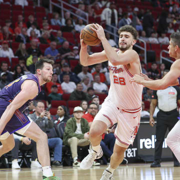 Feb 23, 2024; Houston, Texas, USA; Houston Rockets center Alperen Sengun (28) drives with the ball as Phoenix Suns guard Grayson Allen (8) defends during the first quarter at Toyota Center. Mandatory Credit: Troy Taormina-USA TODAY Sports