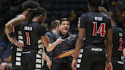 Feb 19, 2025; Morgantown, West Virginia, USA; Cincinnati Bearcats head coach Wes Miller talks to his team late in the second half against the West Virginia Mountaineers at WVU Coliseum. Mandatory Credit: Ben Queen-Imagn Images