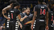 Feb 19, 2025; Morgantown, West Virginia, USA; Cincinnati Bearcats head coach Wes Miller talks to his team late in the second half against the West Virginia Mountaineers at WVU Coliseum. Mandatory Credit: Ben Queen-Imagn Images