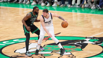 Jun 9, 2024; Boston, Massachusetts, USA; Dallas Mavericks guard Luka Doncic (77) dribbles the ball against Boston Celtics guard Jaylen Brown (7) during the second quarter in game two of the 2024 NBA Finals at TD Garden. Mandatory Credit: Peter Casey-USA TODAY Sports