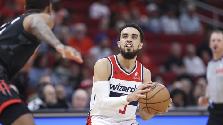 Mar 14, 2024; Houston, Texas, USA; Washington Wizards guard Tyus Jones (5) pulls up to shoot the ball during the third quarter against the Houston Rockets at Toyota Center. Mandatory Credit: Troy Taormina-USA TODAY Sports