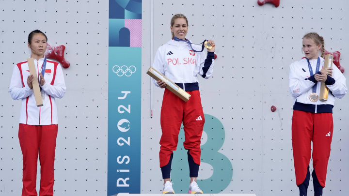 Aug 7, 2024; Le Bourget, France; Lijuan Deng (CHN), Aleksandra Miroslaw (POL), and Aleksandra Kalucka (POL) celebrate their medals in womenís speed climbing during the Paris 2024 Olympic Summer Games at Le Bourget Sport Climbing Venue.