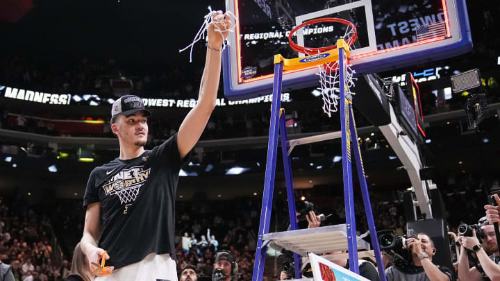 Purdue Boilermakers center Zach Edey (15) holds up a piece of the net Sunday, March 31, 2024, after