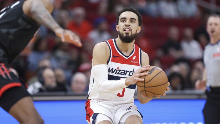 Mar 14, 2024; Houston, Texas, USA; Washington Wizards guard Tyus Jones (5) pulls up to shoot the ball during the third quarter against the Houston Rockets at Toyota Center. Mandatory Credit: Troy Taormina-USA TODAY Sports