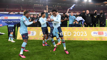 Burnley's players celebrate promotion back to the Premier League