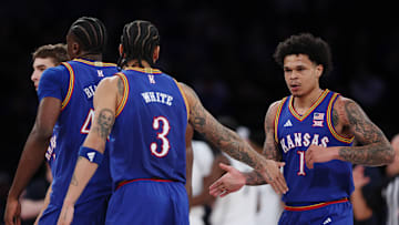 Kansas basketball players Tre White (3) and Jayden Dawson (1)