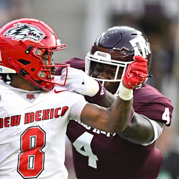 Sep 2, 2023; College Station, Texas, USA; New Mexico Lobos wide receiver Jeremiah Hixon (8) runs the ball during the second quarter as Texas A&M Aggies defensive lineman Shemar Stewart (4) makes a tackle at Kyle Field. Mandatory Credit: Maria Lysaker-Imagn Images