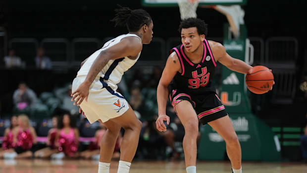 Jan 29, 2025; Coral Gables, Florida, USA; Miami Hurricanes guard Divine Ugochukwu (99) dribbles the basketball as Virginia Ca